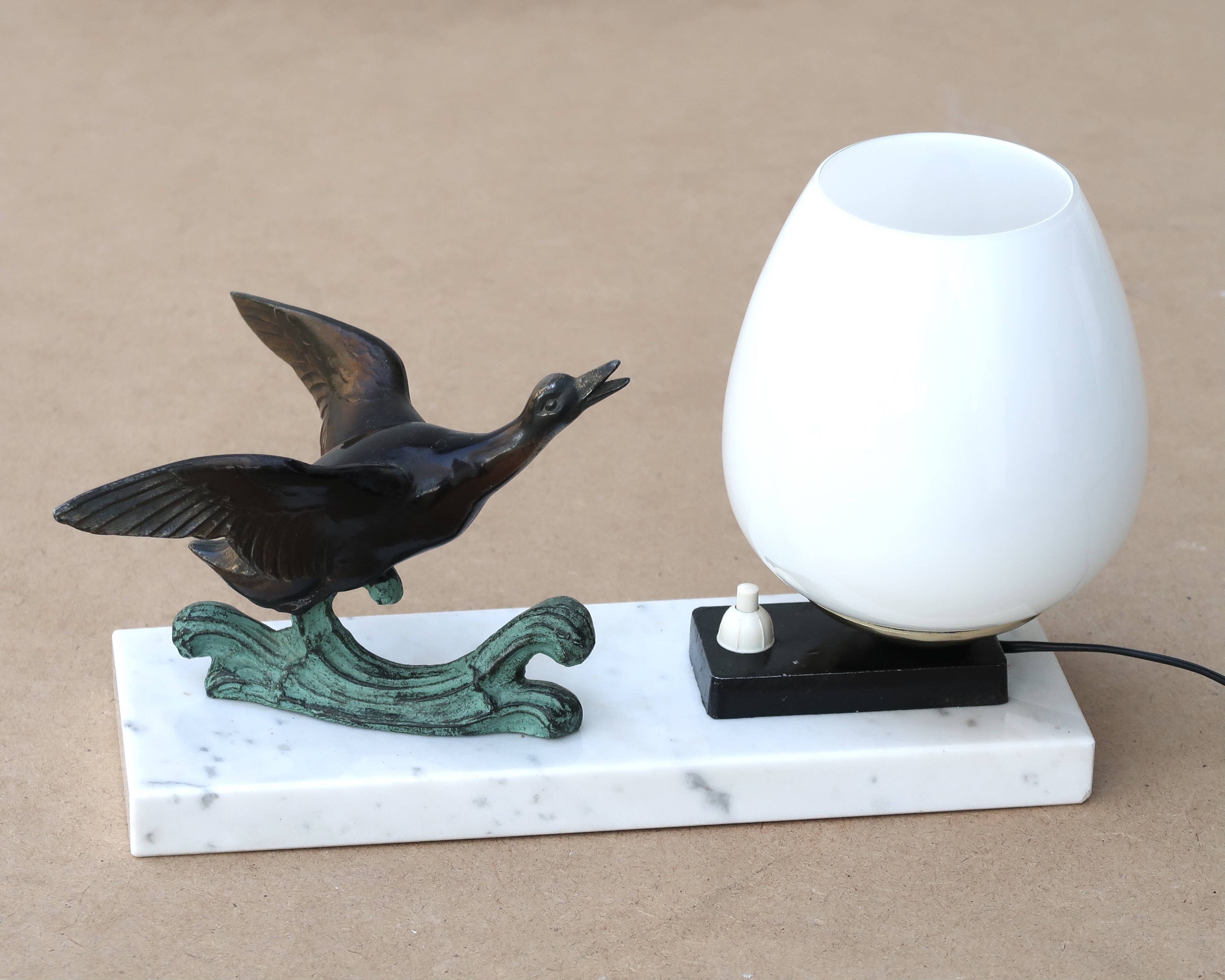 Art Deco lamp decorated with a flying duck, marble base, 1930s.