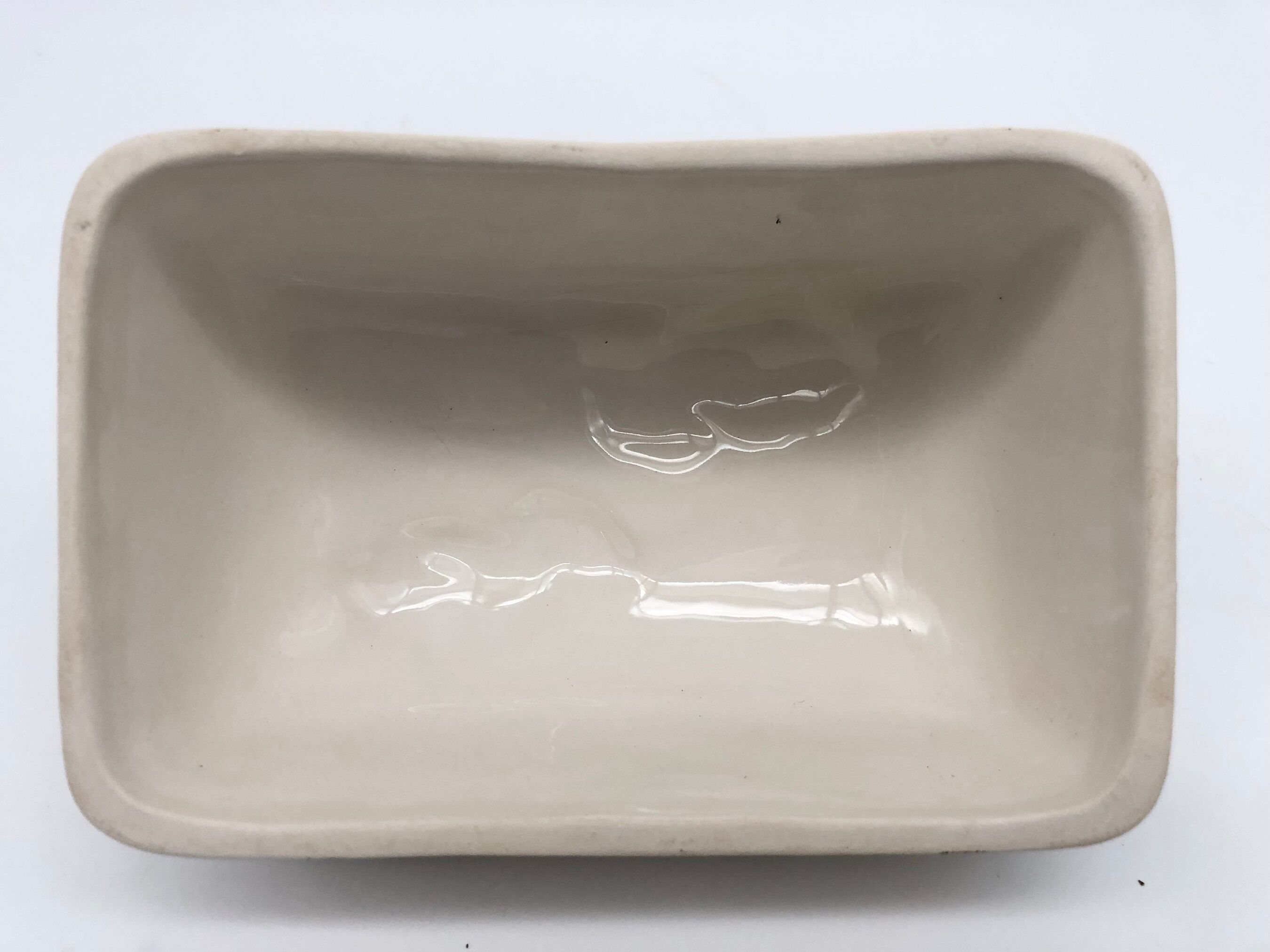 Slurry butter dish, with radish drawings. Signed "FG"