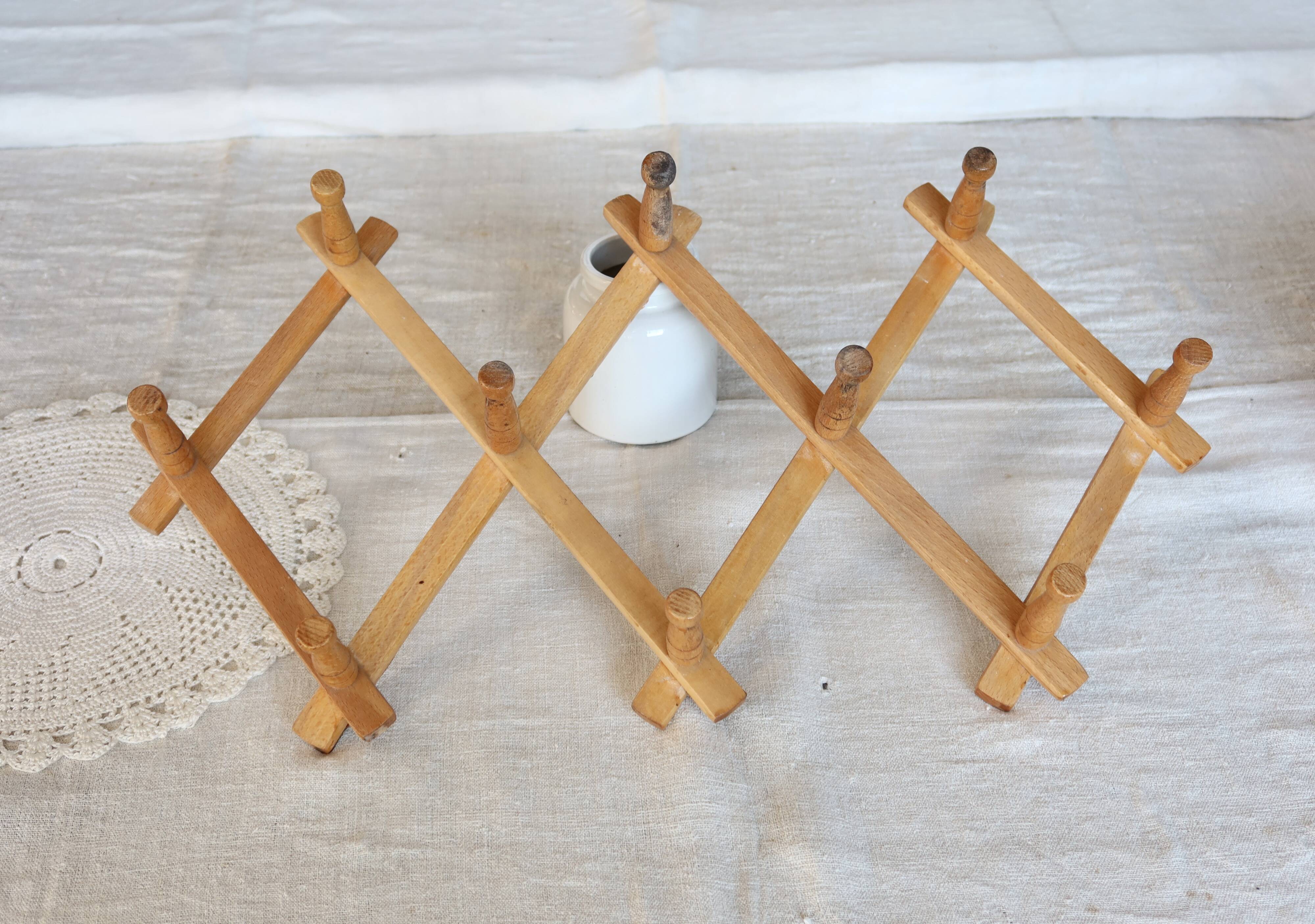 Vintage retractable wall-mounted coat rack made of pine wood