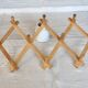 Vintage retractable wall-mounted coat rack made of pine wood