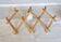 Vintage retractable wall-mounted coat rack made of pine wood
