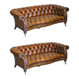 Pair of leather Chesterfield sofas by Howard & Sons