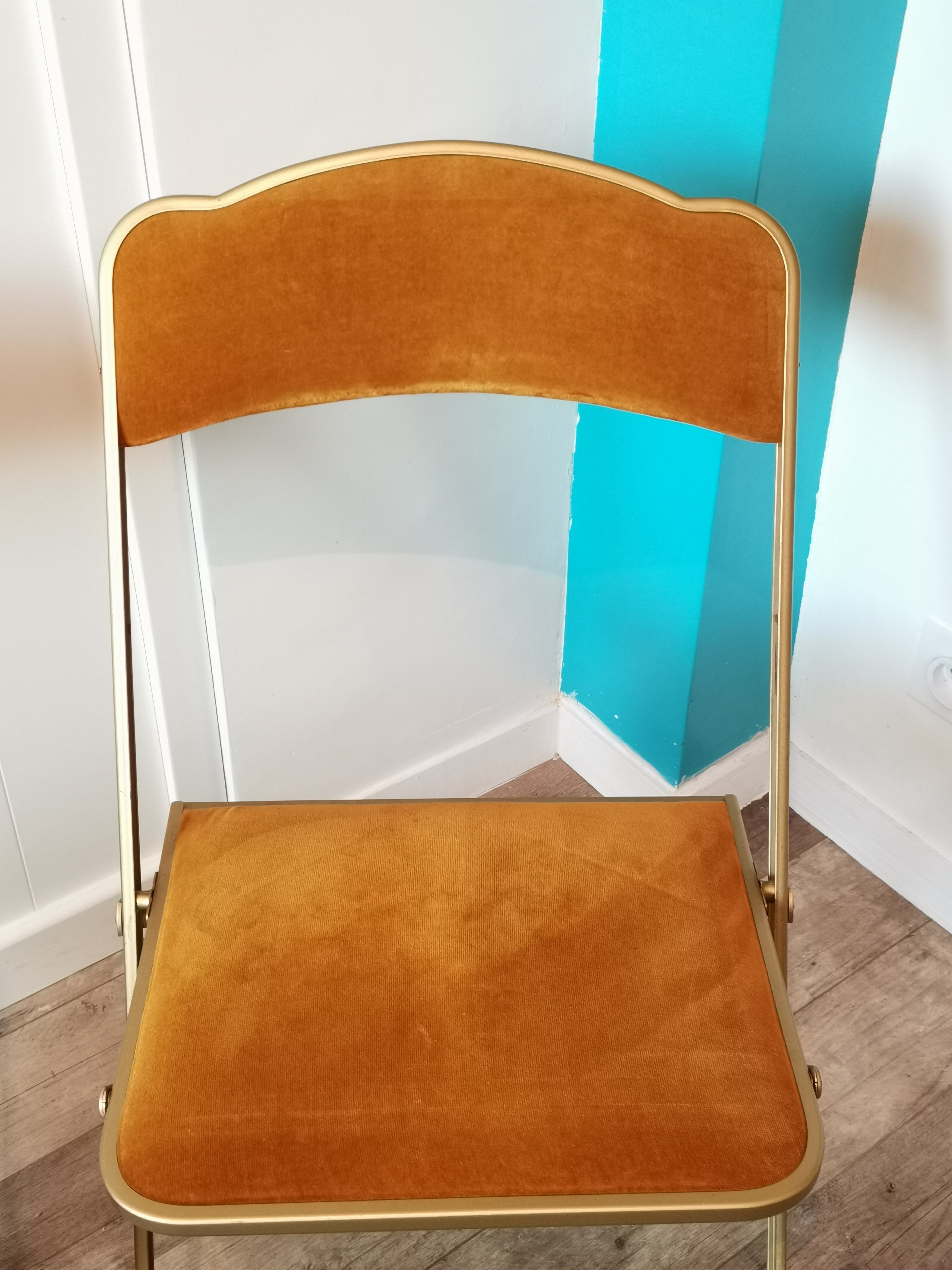Two gold velvet folding chairs