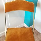 Two gold velvet folding chairs