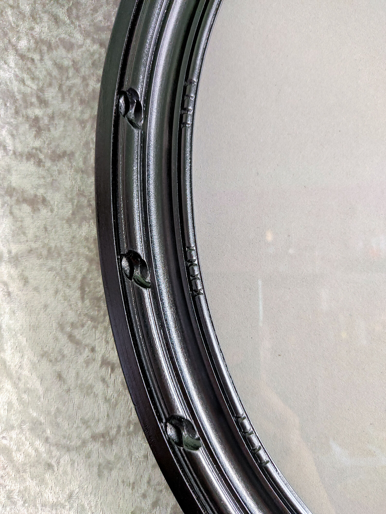 Oval frame in black varnished carved wood