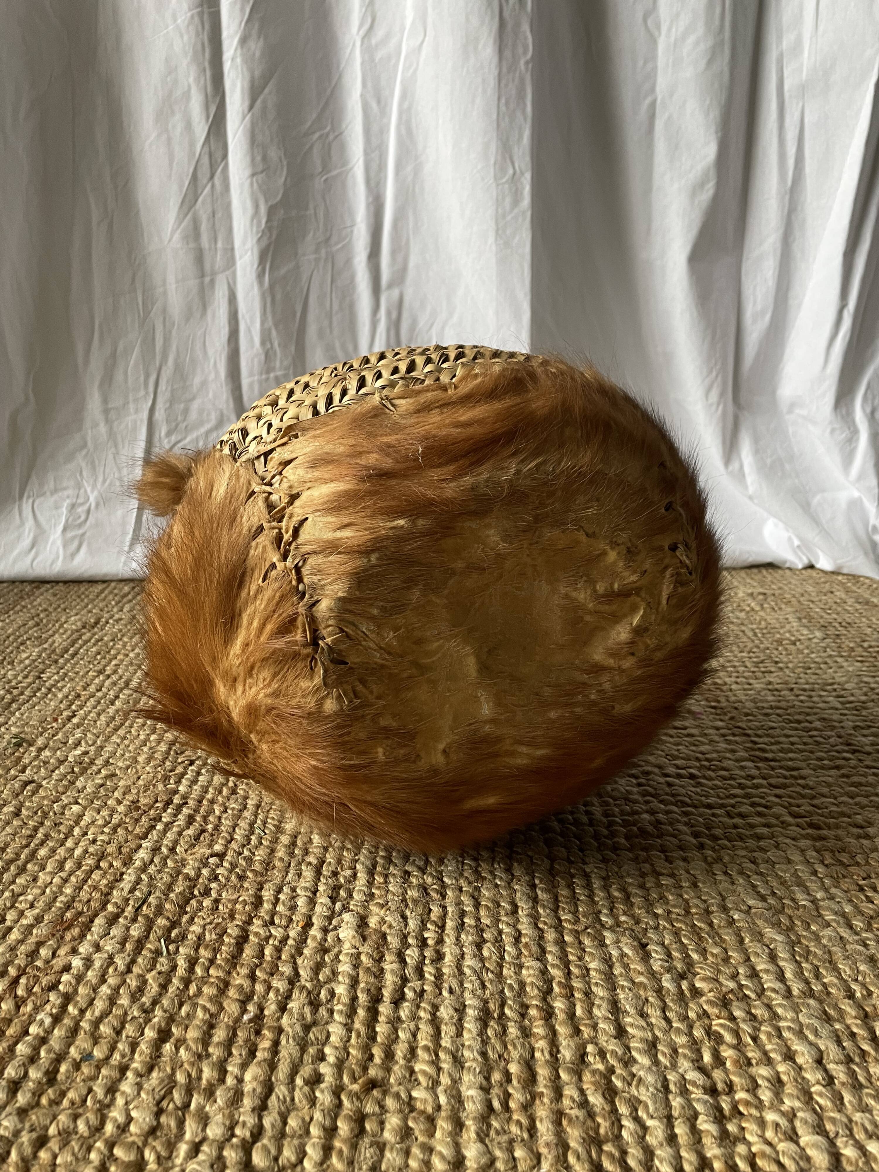 Handwoven vintage basket with handles made from natural fibres.