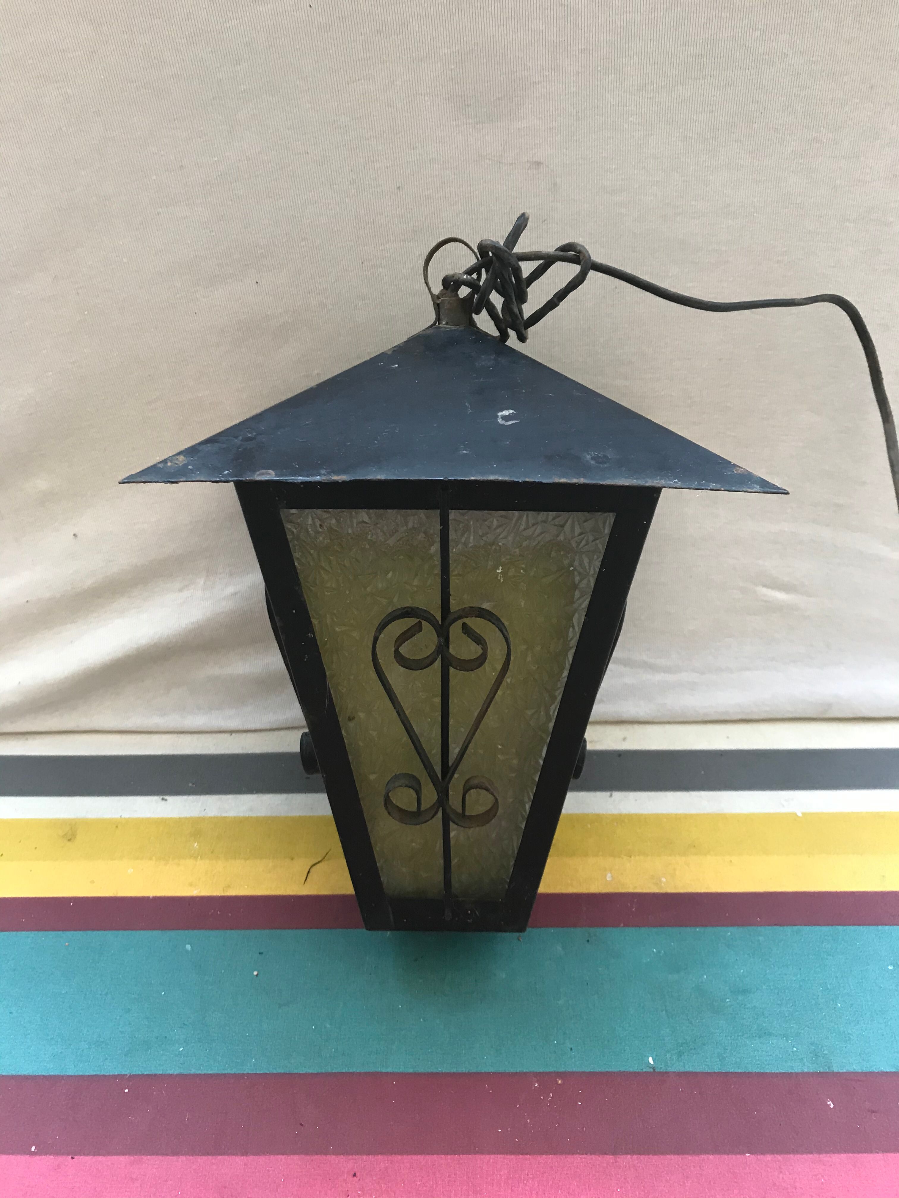 Old black forged iron suspension vintage in moulded glass