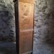 French antique wardrobe with curtain in oak, circa 1920–1930.