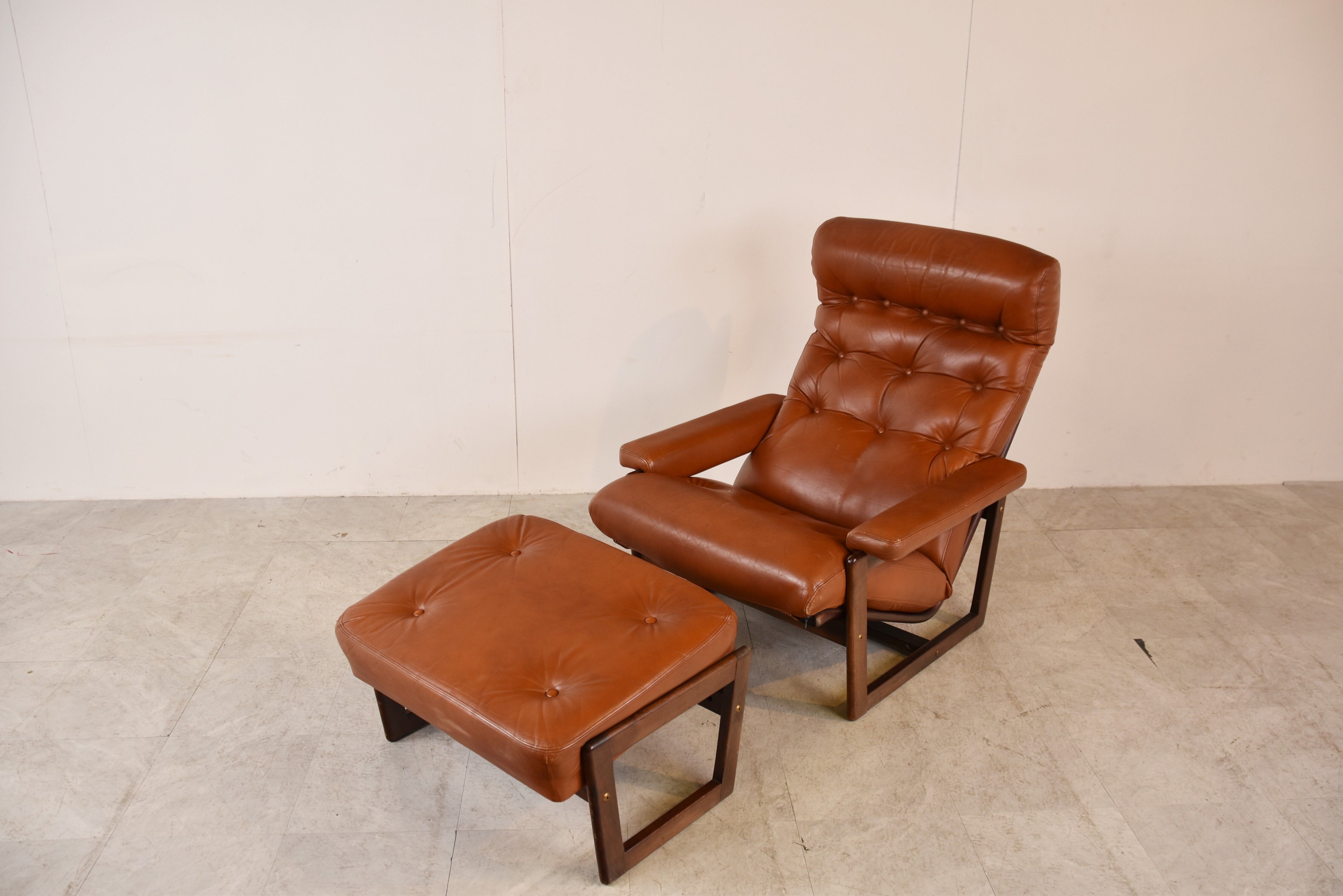 Vintage leather armchair with hocker, 1970s