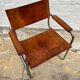Vintage aluminum tube and tan leather armchair