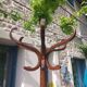 dark-coloured wooden coat rack parrot