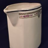 Old covered jug, vintage, geometric frieze with flowers and black trim.