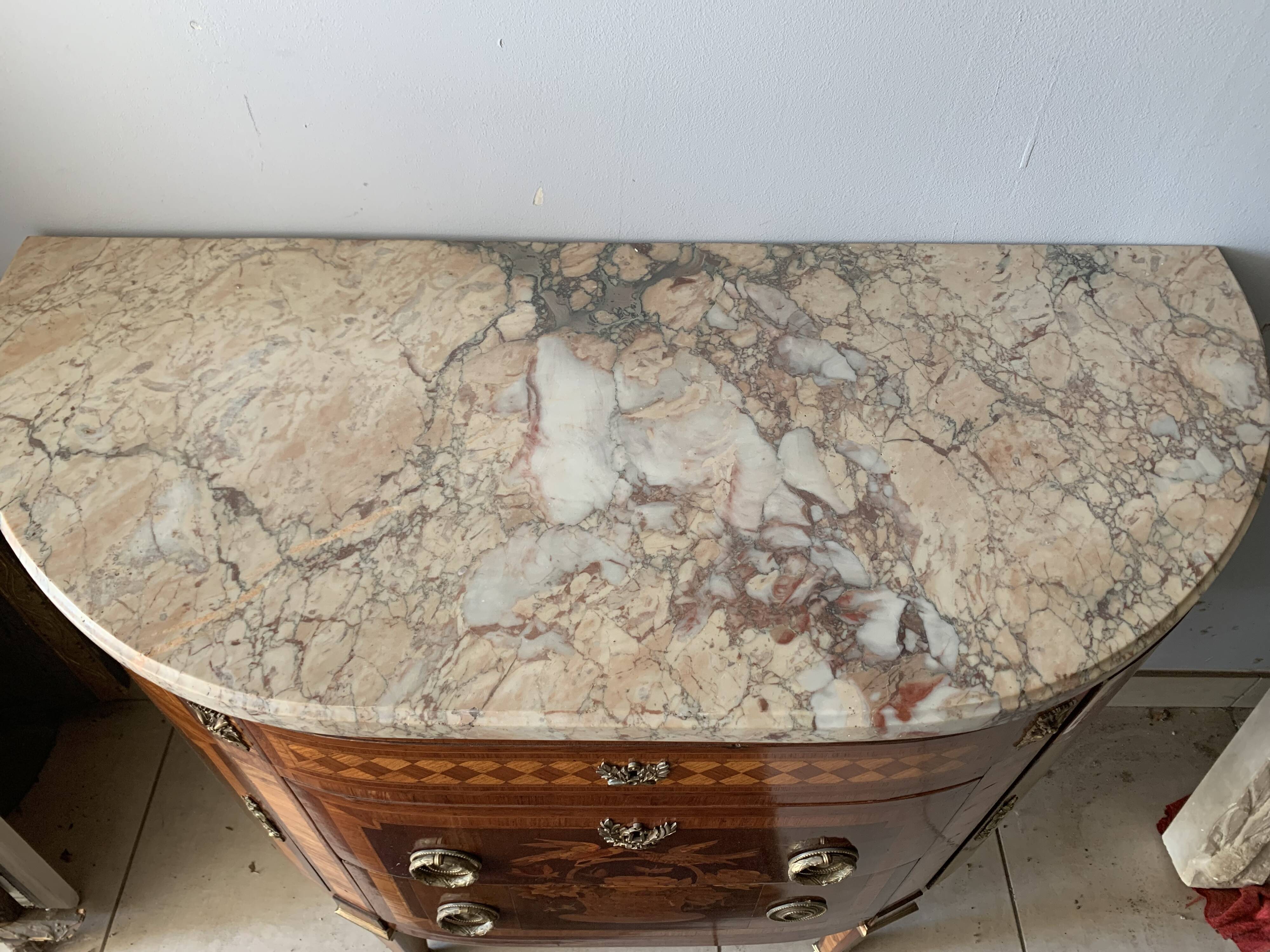 Louis XVI style half-moon chest of drawers in late nineteenth century marquetry