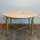 Brass coffee table with a white marble top.
