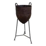 Old metal pot on foot