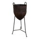 Old metal pot on foot
