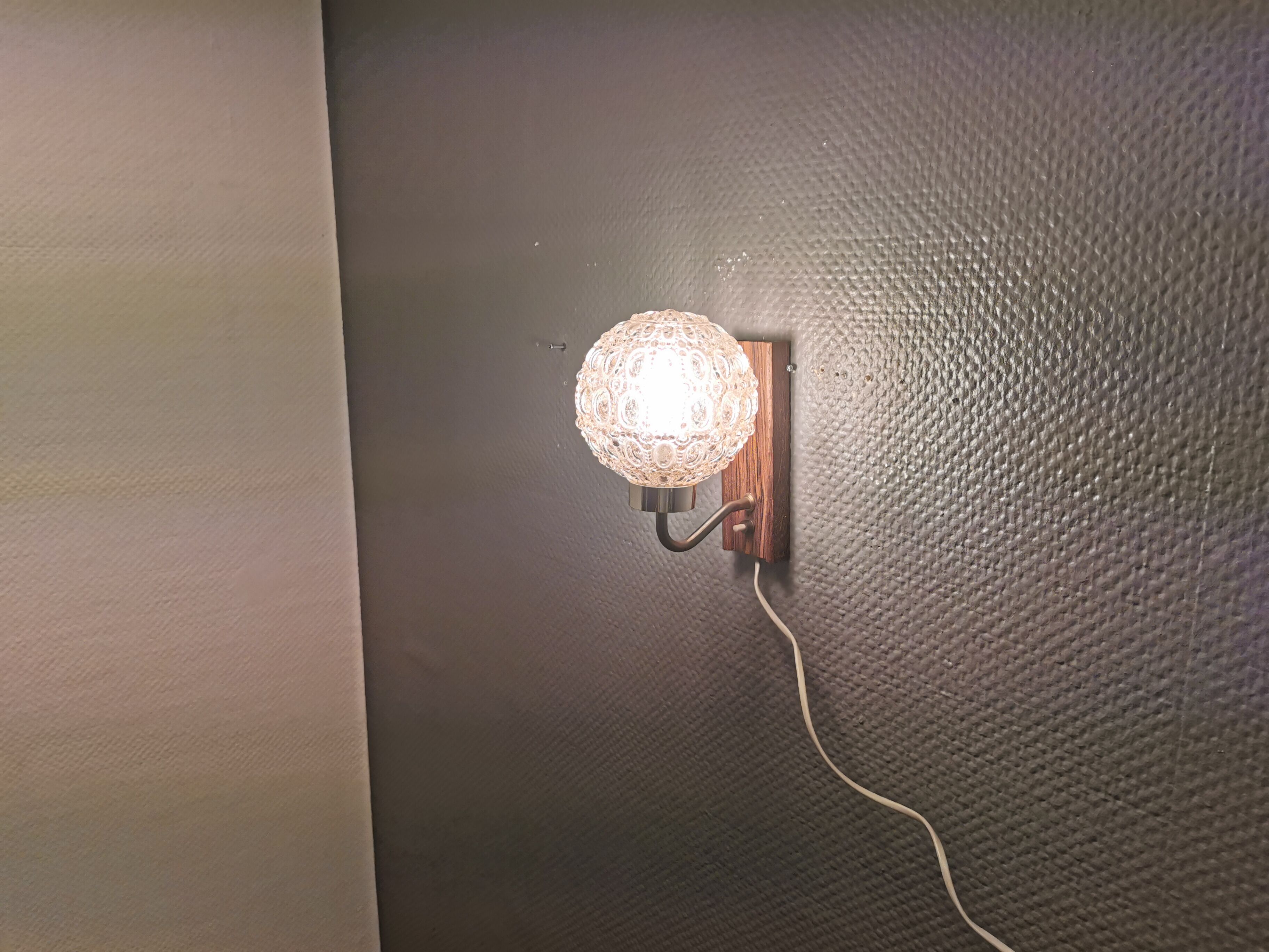 Wall light in rosewood with bobble glass ball shade.