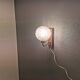 Wall light in rosewood with bobble glass ball shade.