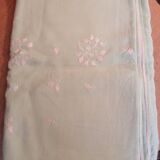 Old embroidered tablecloth in light green color