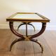 Coffee table in patinated and gilded carved wood with mirror top