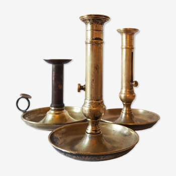 Set of three old brass candle holders