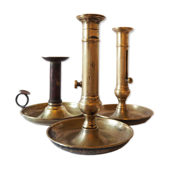 Set of three old brass candle holders