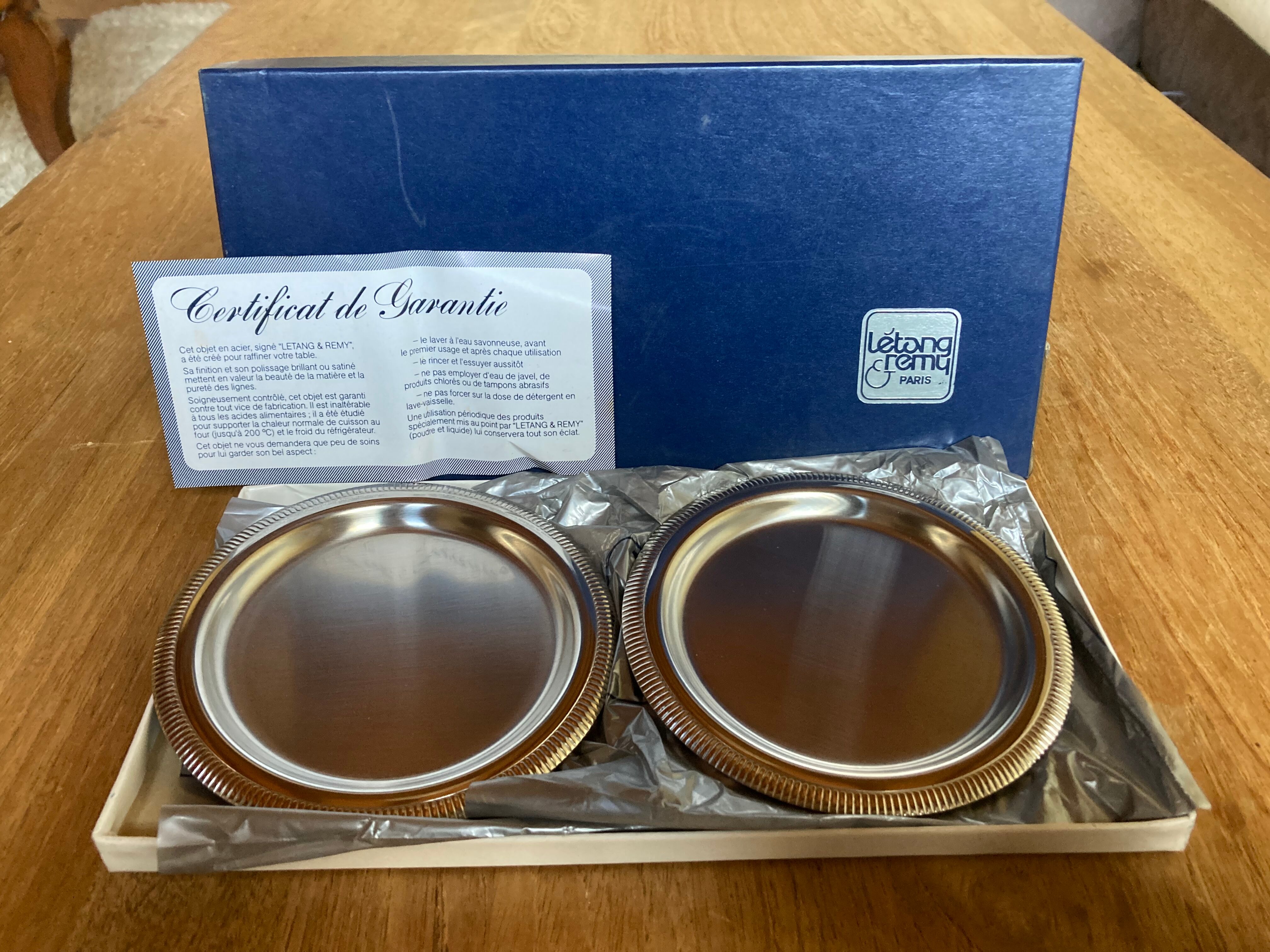 Pair of stainless steel bottle coasters létang and rémy