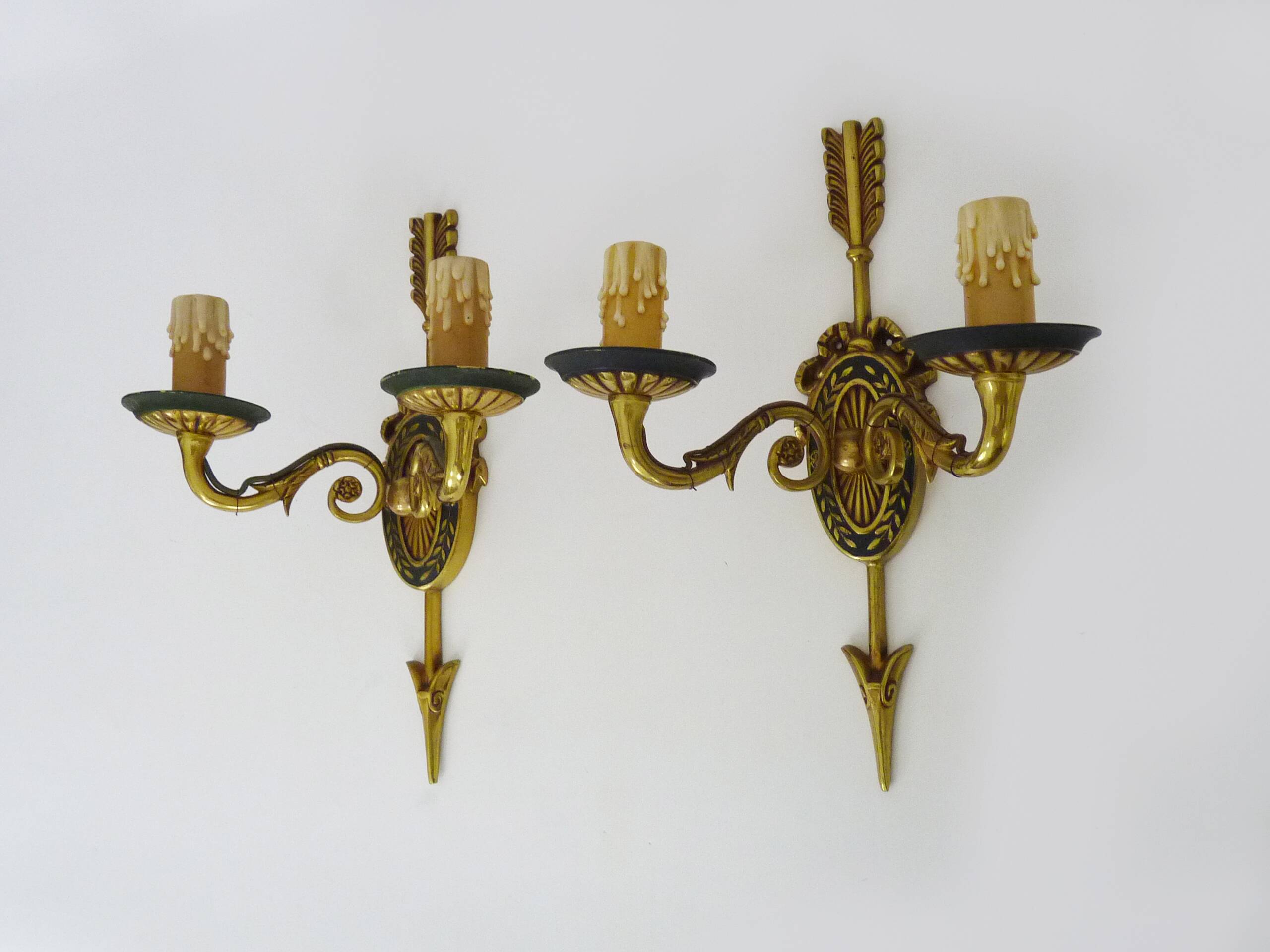 Pair of double-light Empire style arrow wall lights in bronze. Early 20th century