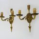 Pair of double-light Empire style arrow wall lights in bronze. Early 20th century