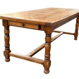 Large farmhouse table made of solid wood.