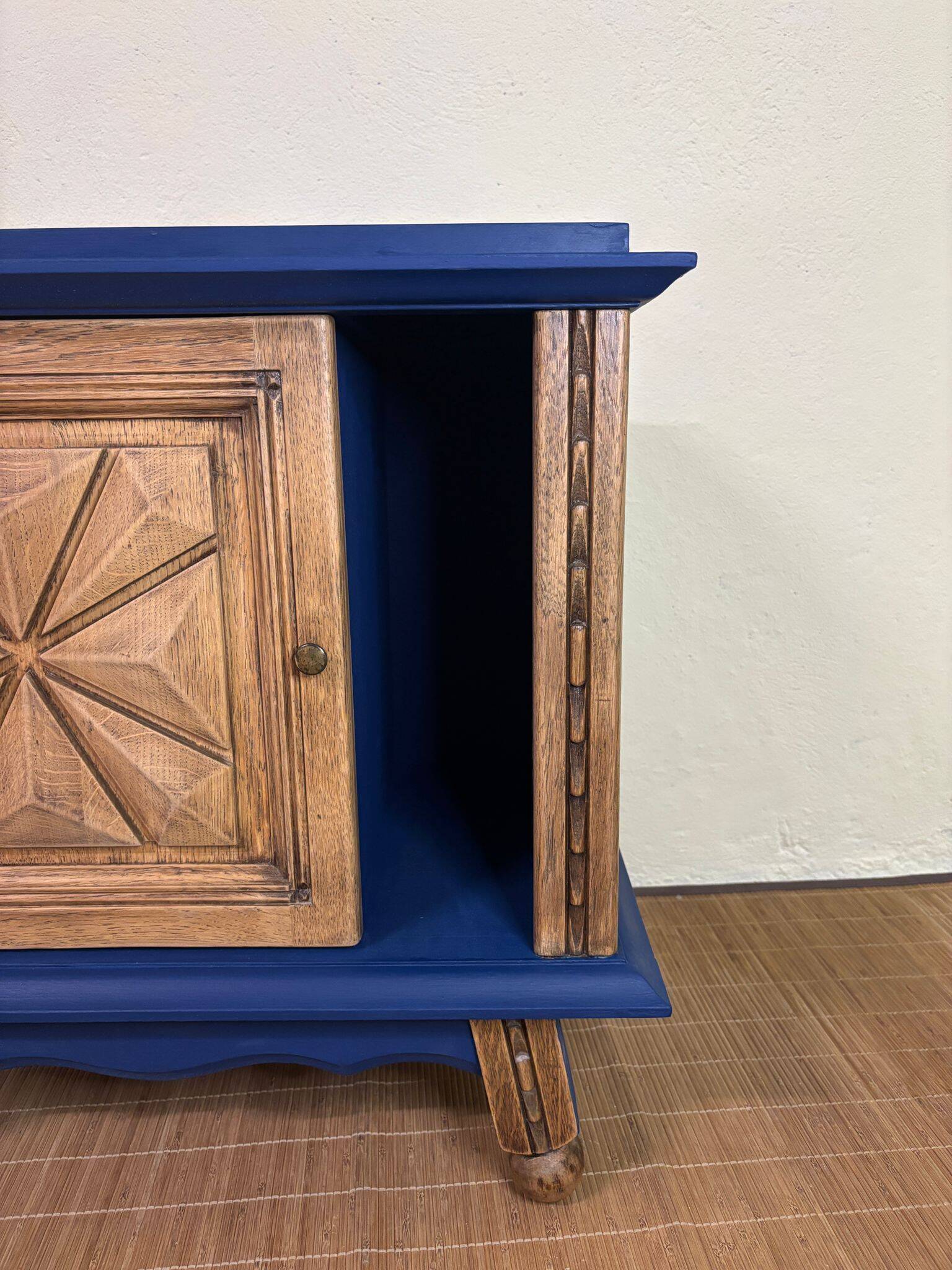 Small vintage upcycled side table in midnight blue and raw wood, with a rose-shaped door.