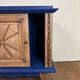 Small vintage upcycled side table in midnight blue and raw wood, with a rose-shaped door.