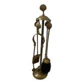 Vintage brass fireplace tool set with shell decoration.