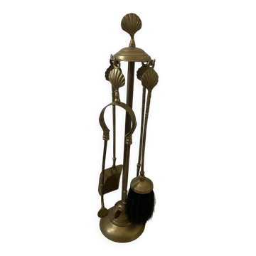Vintage brass fireplace companion with shell decoration.