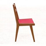 Vintage chairs from the 1950s in wood and faux leather.