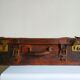 Old cardboard suitcase covered with patinated leather