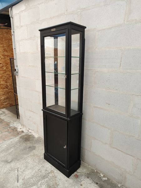 Old wooden window of black patina store two doors