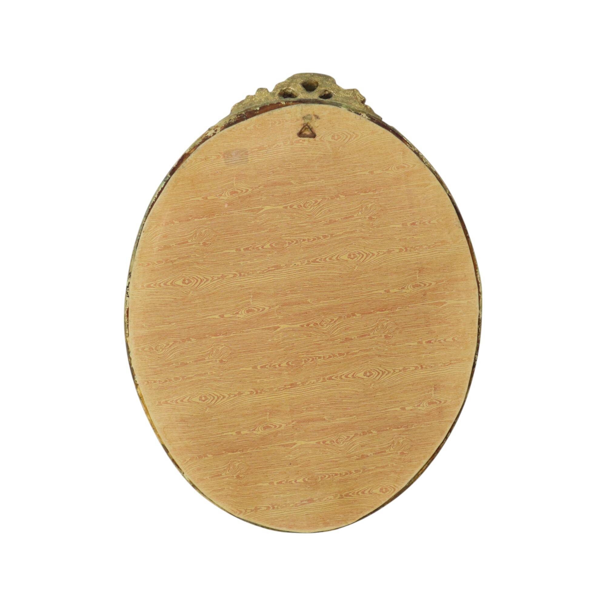 Miroir ovale vintage en résine dorée à la feuille d'or, style années 60. Classique.