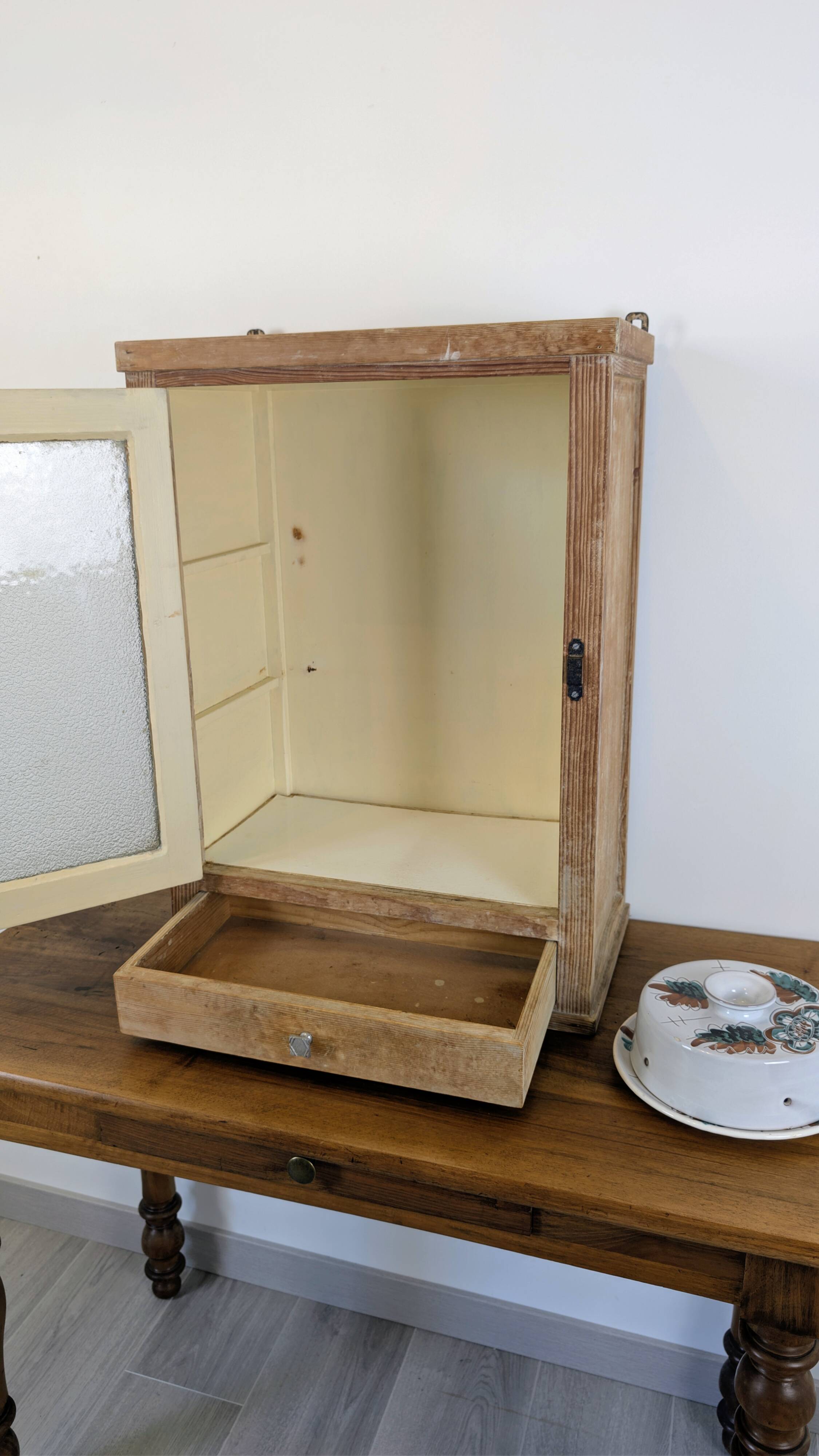 Small glass wall cabinet from the 1960s.
