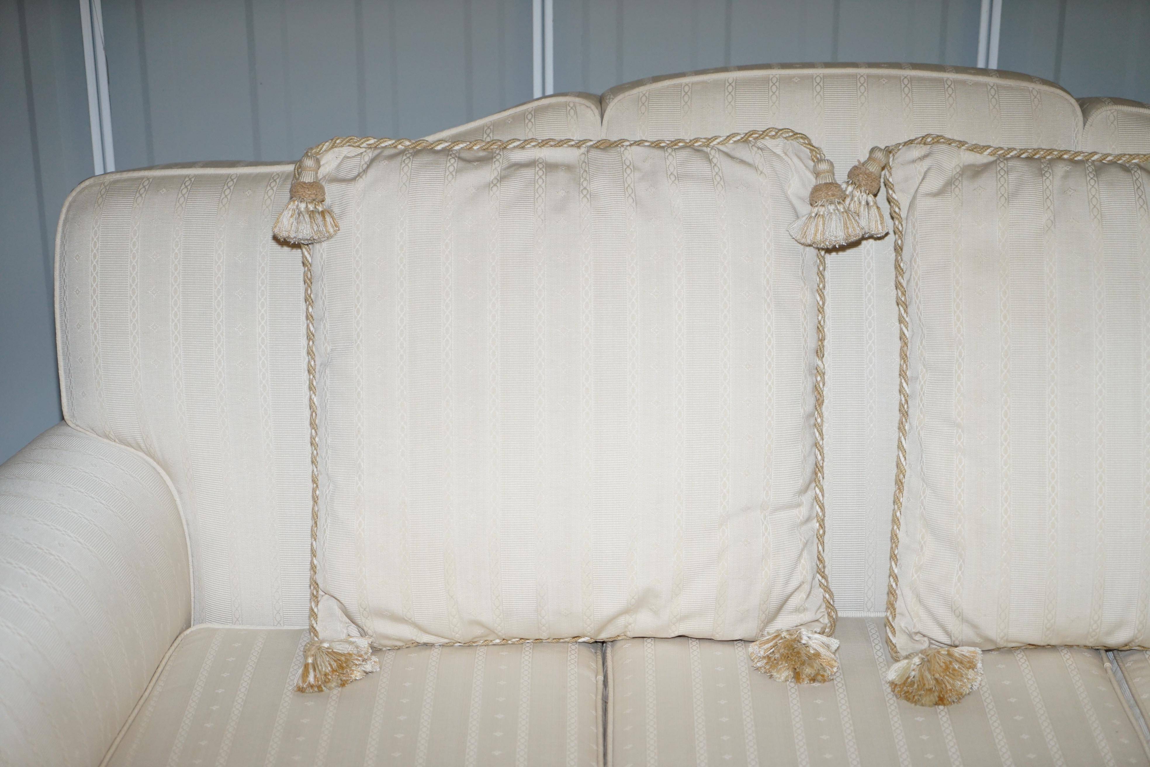 Three-seater canapé carved from solid walnut with claw feet.