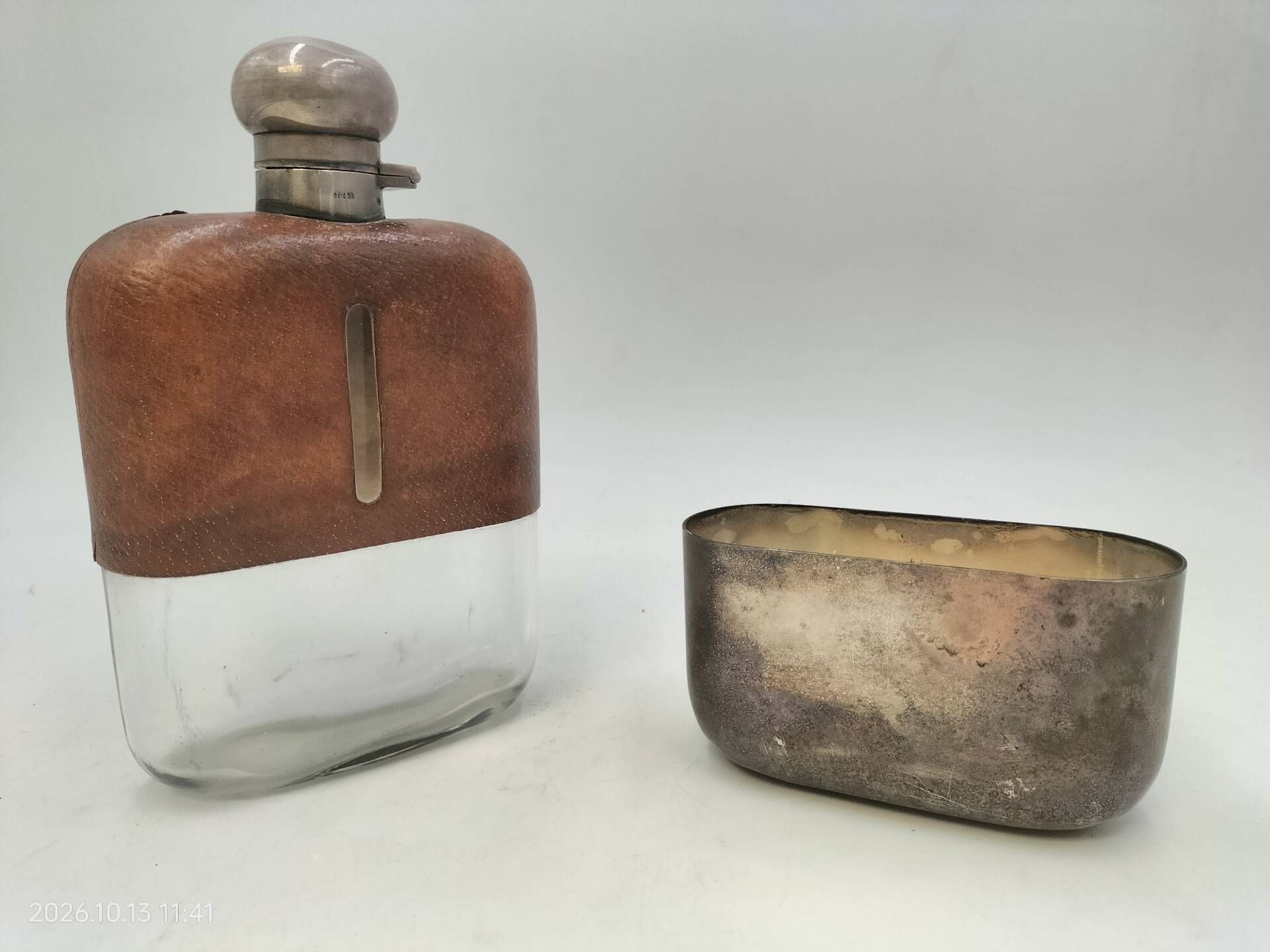 Silver-plated metal flask with leather and glass