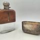 Silver-plated metal flask with leather and glass