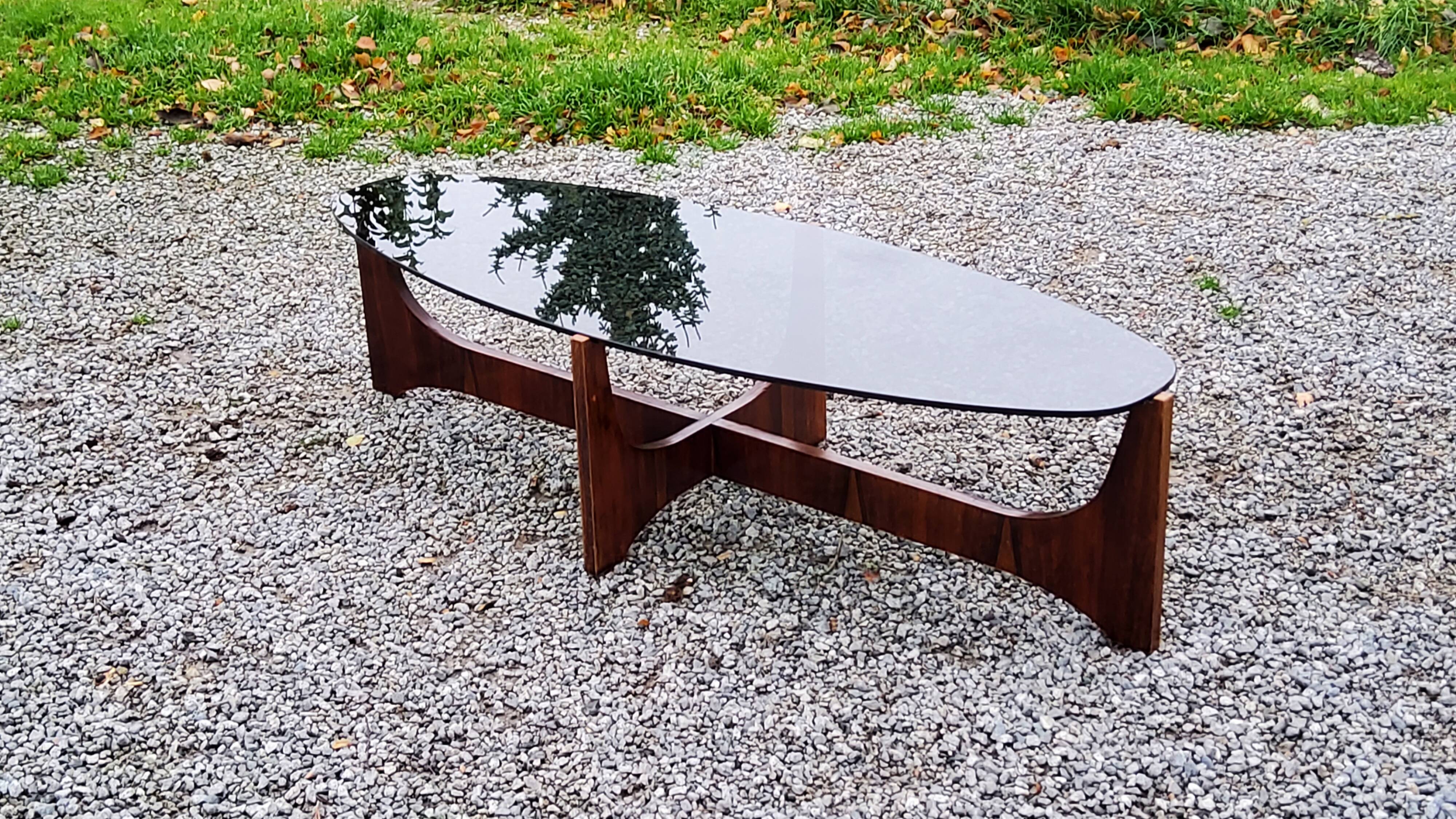 Designer coffee table by Hugues Poignant in rosewood and smoked glass from the 70s