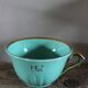 Green and gold cup from the Moi Salins collection.