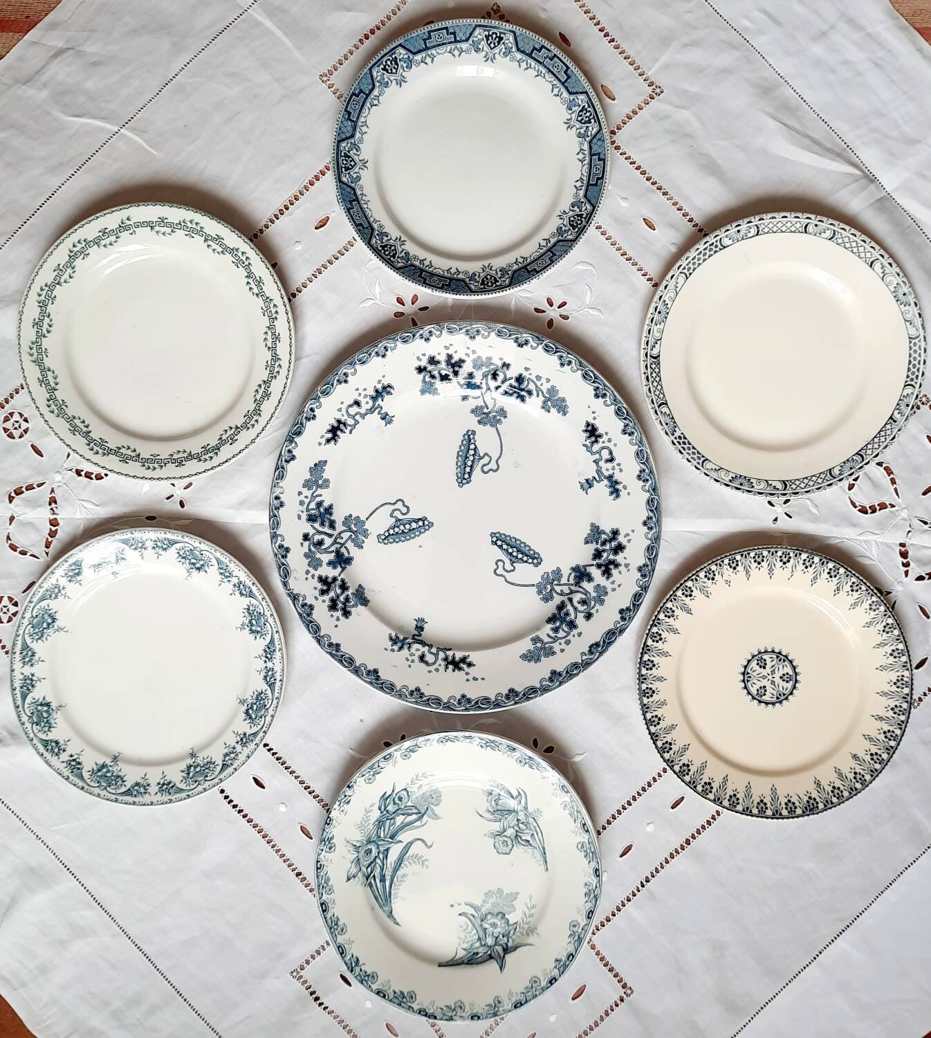 Old mismatched iron earthenware dessert plates accompanied by a dish