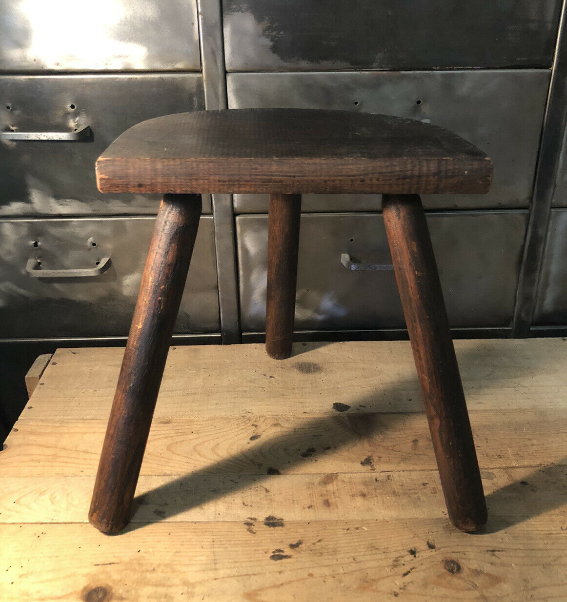 Wooden milking stool on tripod base