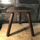 Wooden milking stool on tripod base