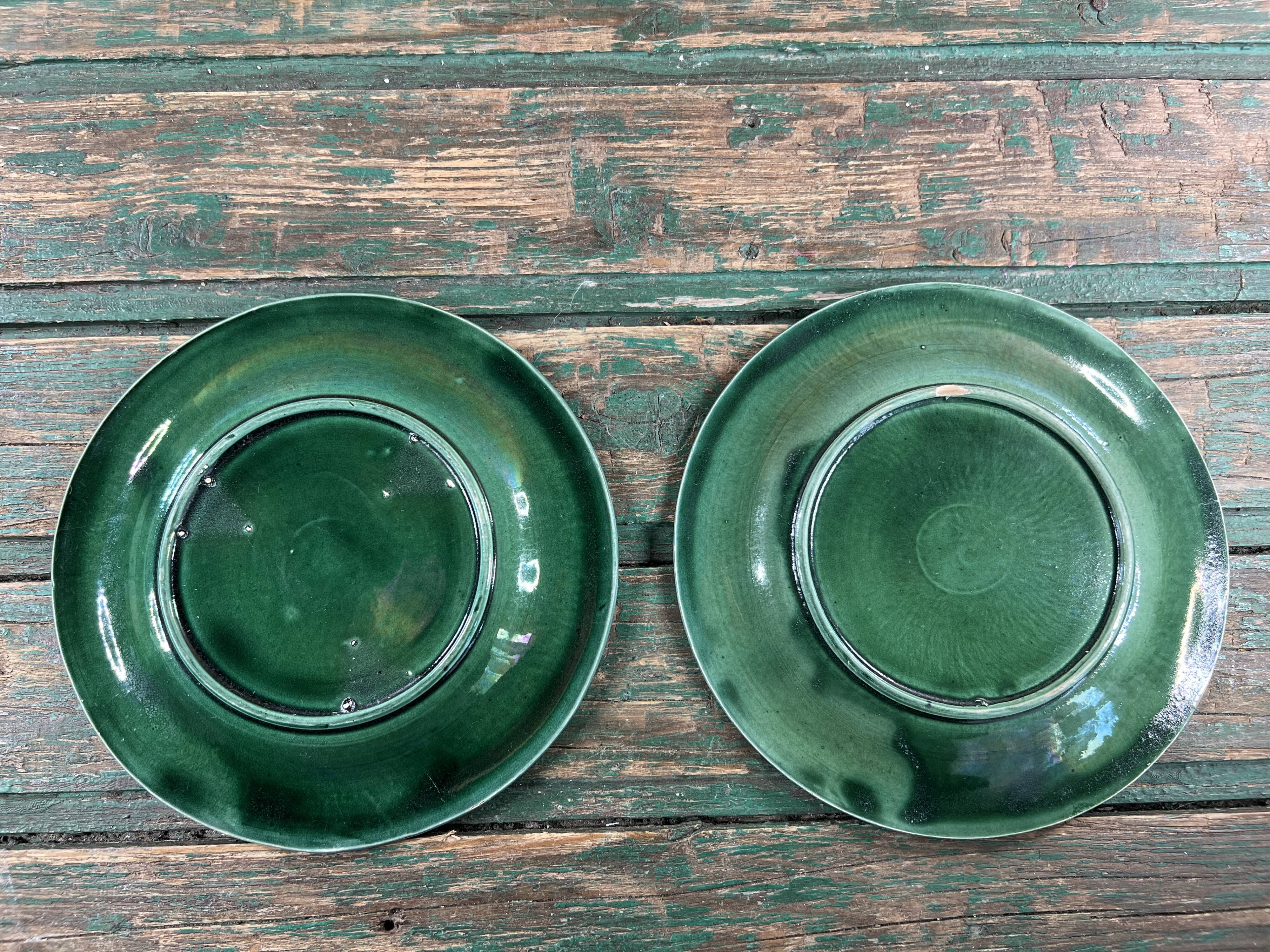 Pair of green slip plates with leaf decoration, 19th century