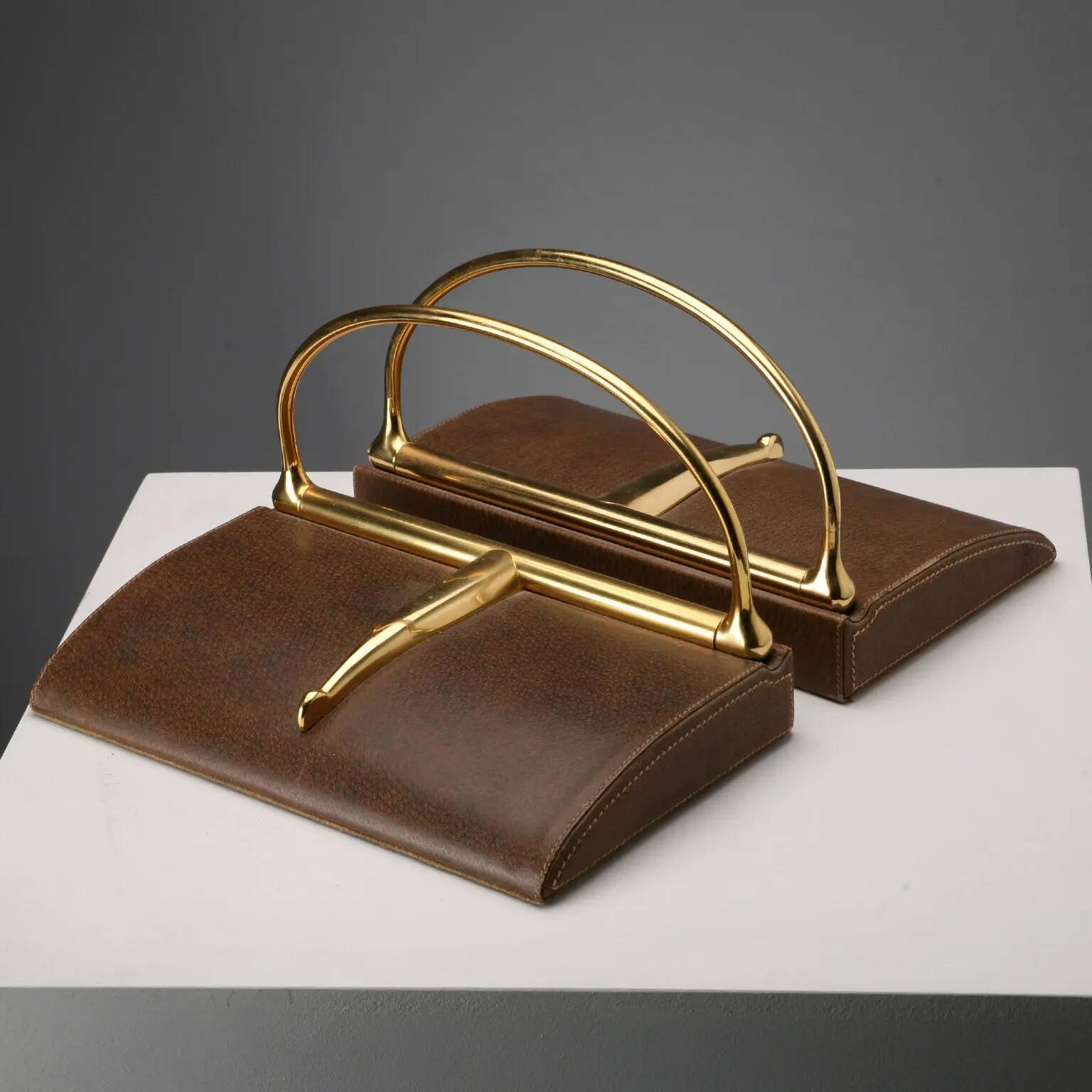 Vintage Gucci bookends in leather and brass, Italy, 1970s.
