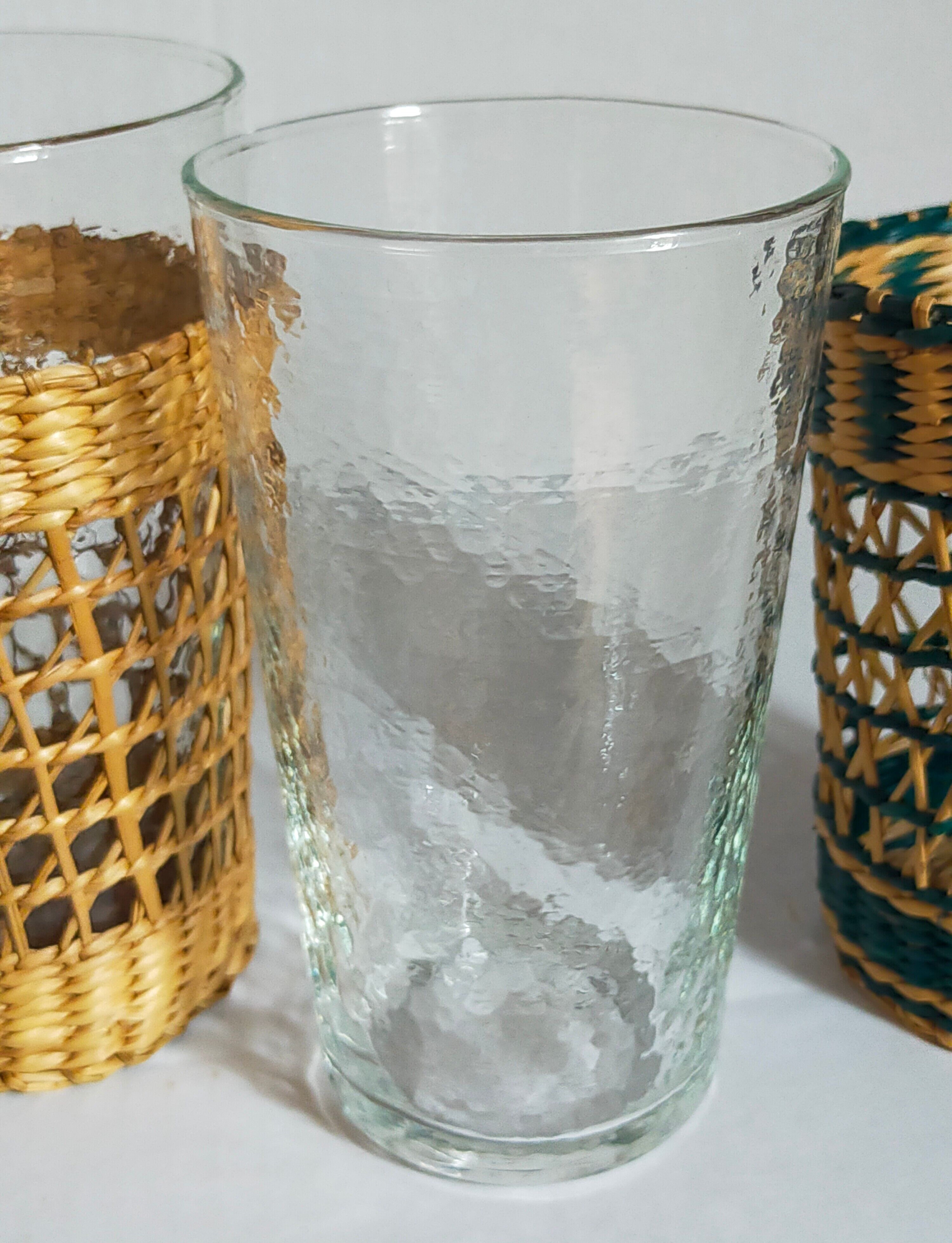Four long drink glasses in vintage woven rattan cases